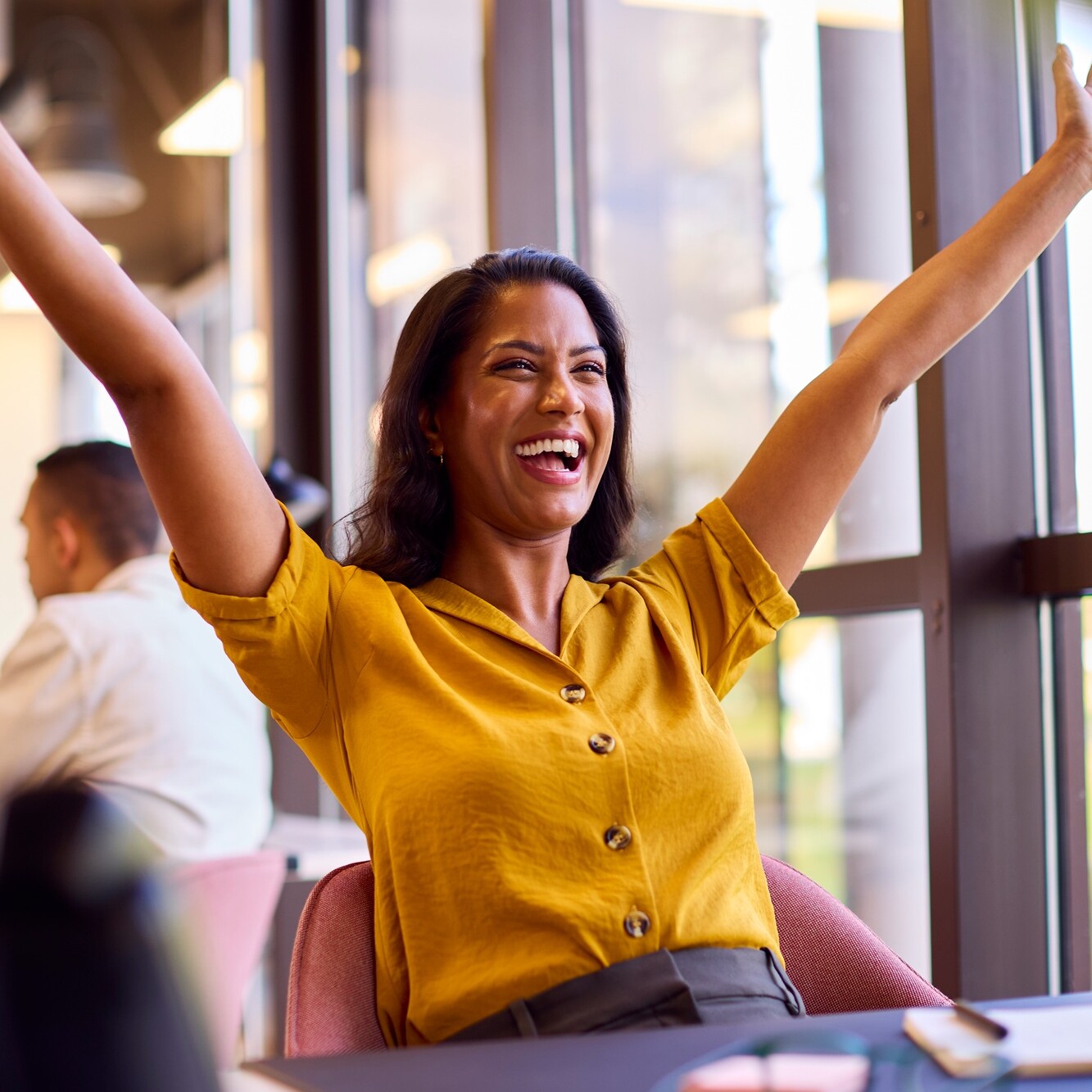 Excited Mature Businesswoman Celebrating Working At Desk In Office