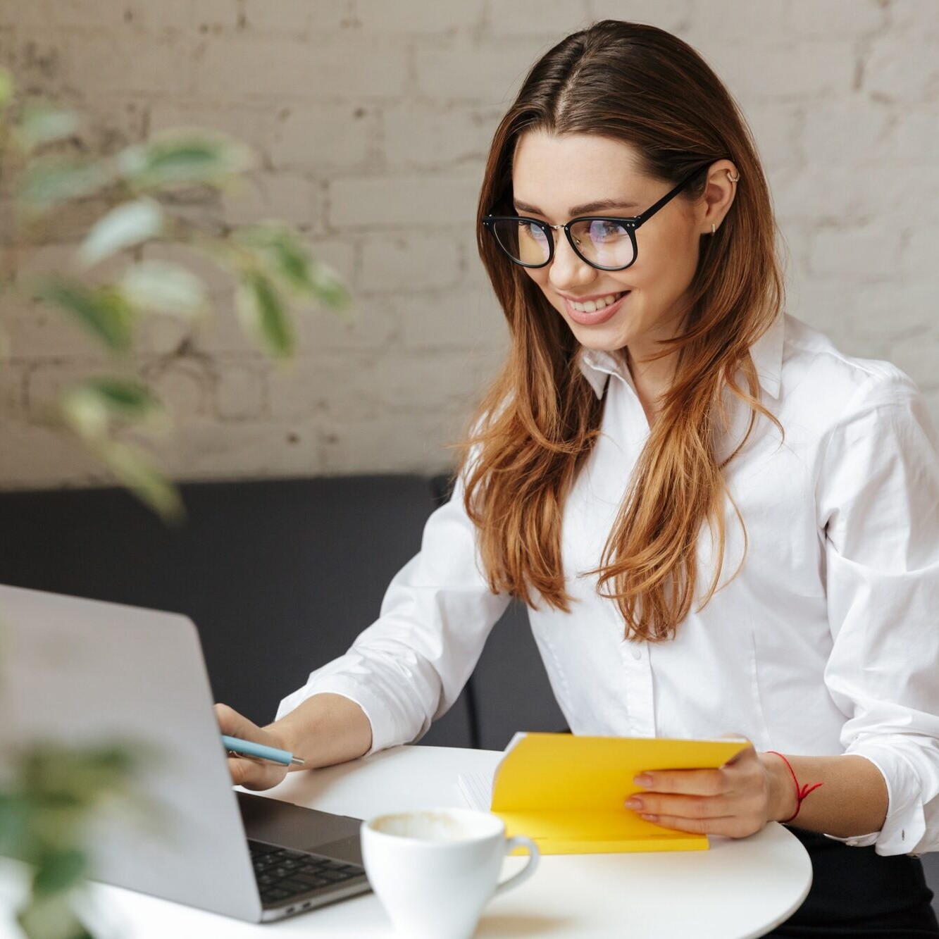 Happy business woman using laptop computer
