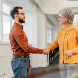 Team smiling business people handshake working in office. Meeting, teamwork, successful deal