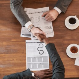 Teamwork and handshake at meeting